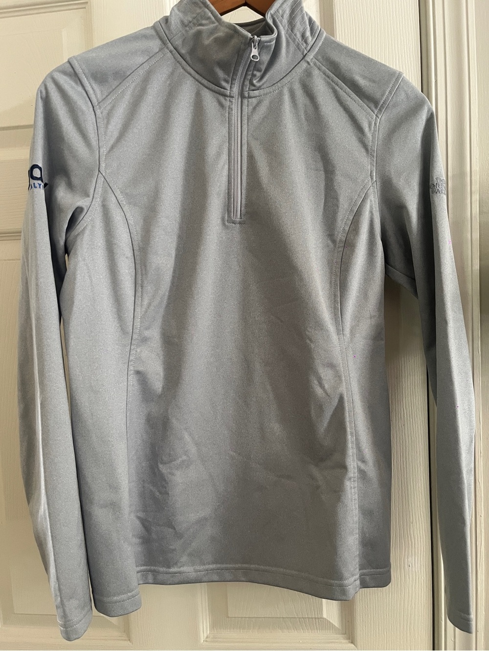 The North Face Light Gray Women's Quarter-Zip Pullover company logo